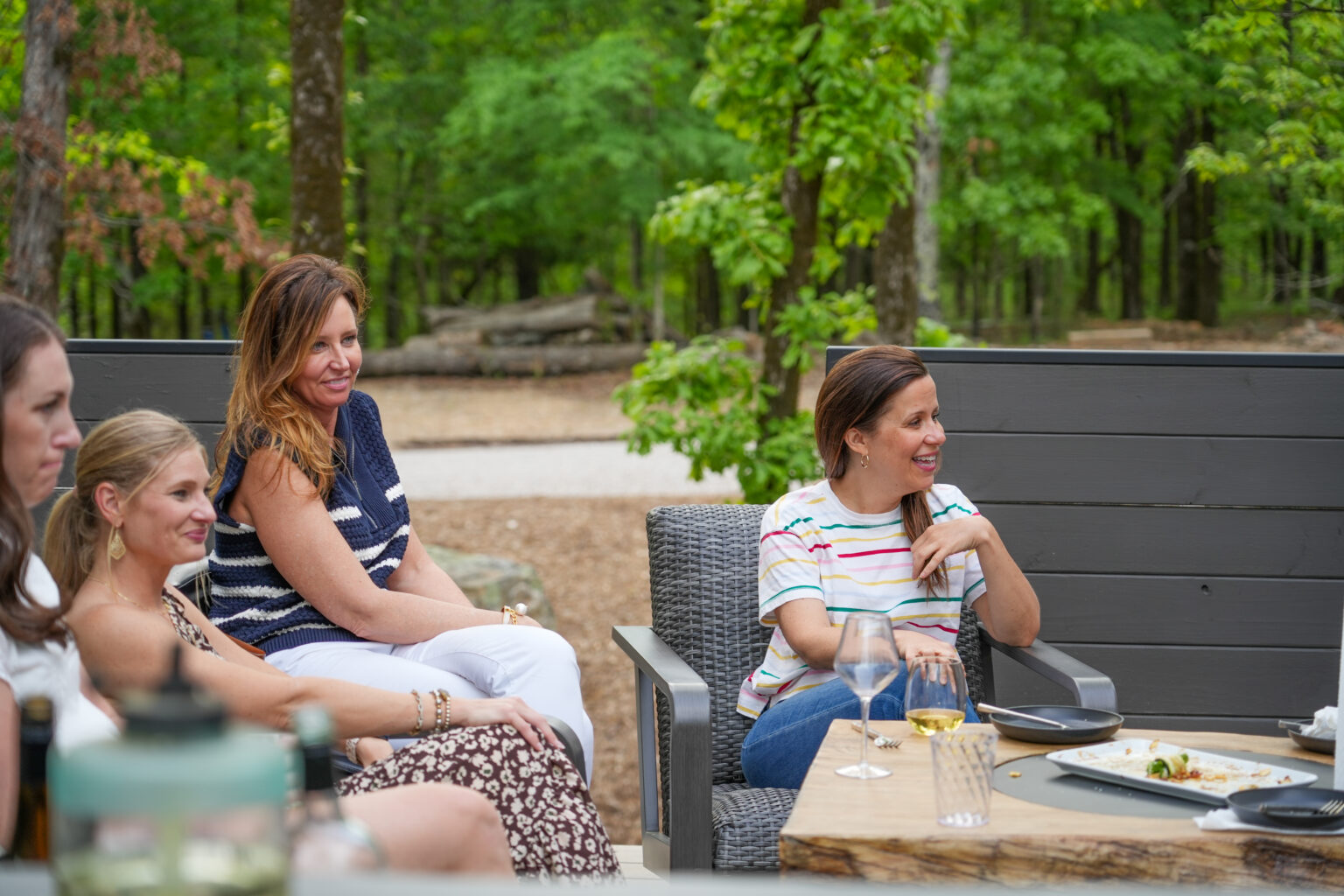 Friends laughing on a treehouse deck