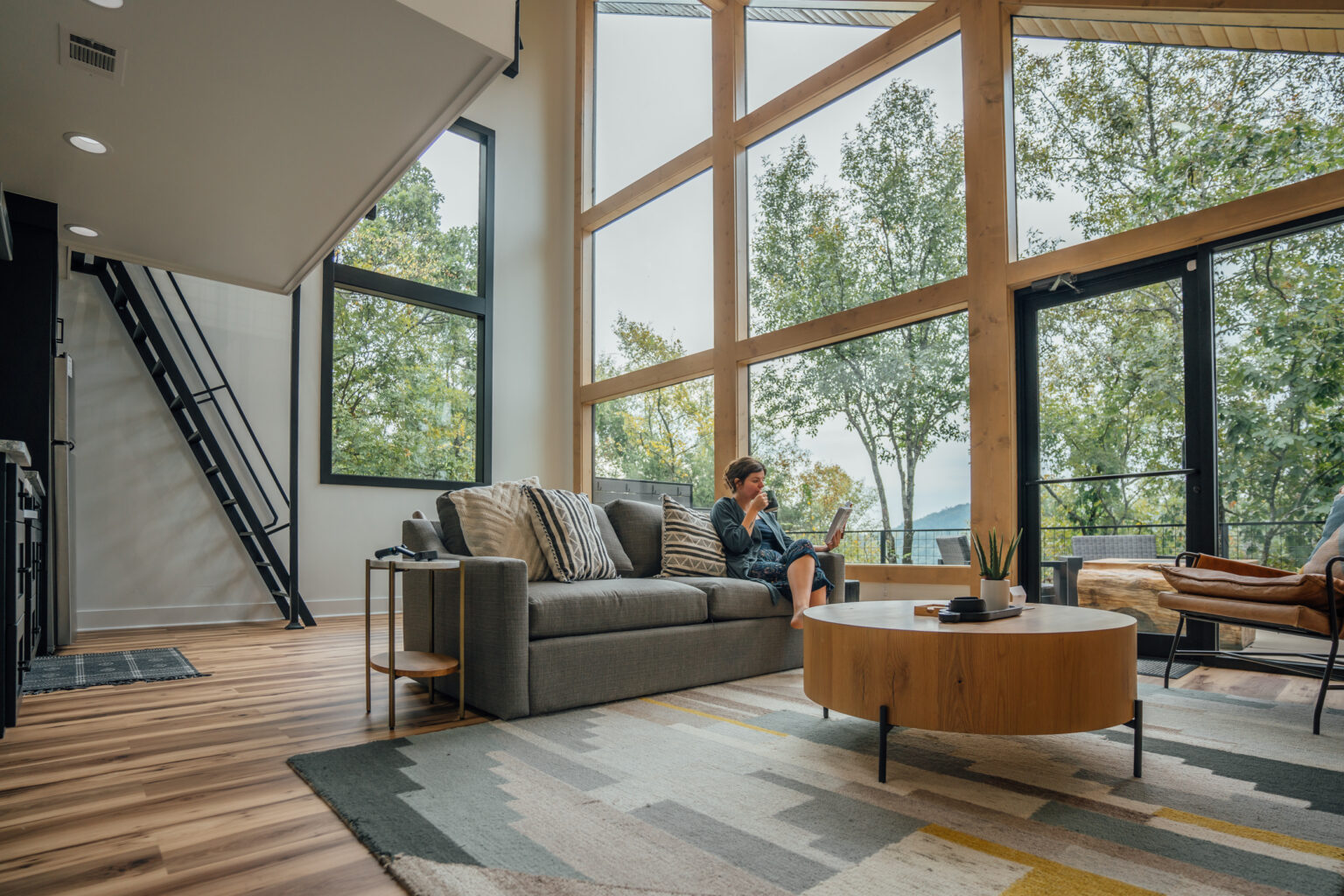 Morning coffee in a treehouse with floor to ceiling windows